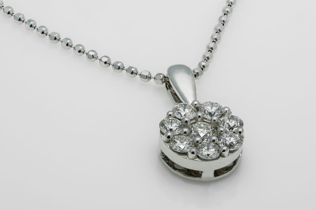 Diamond Necklaces A close-up shot of a luxury diamond pendant necklace with a shiny metallic chain.