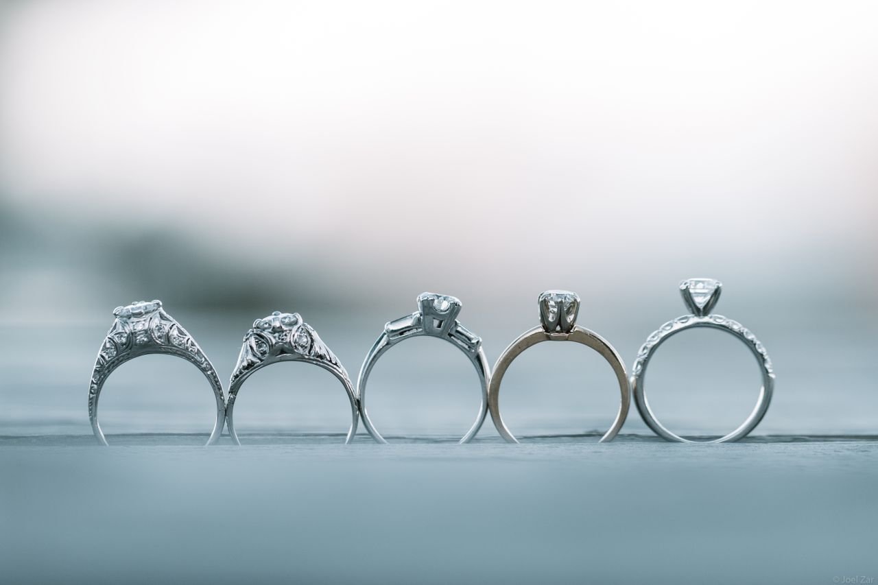 Cocktail Rings Close-up of intricately designed diamond engagement rings with shallow depth of field.