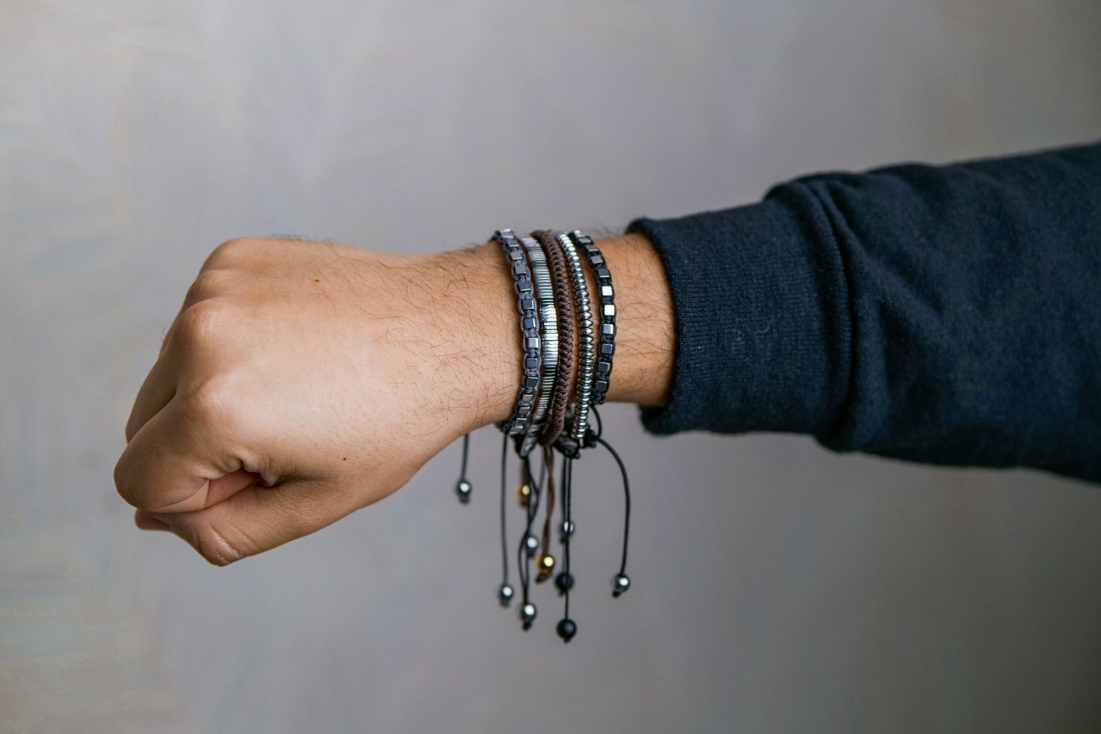 Stylish collection of men's bracelets elegantly displayed on a wrist, showcasing modern fashion accessories.