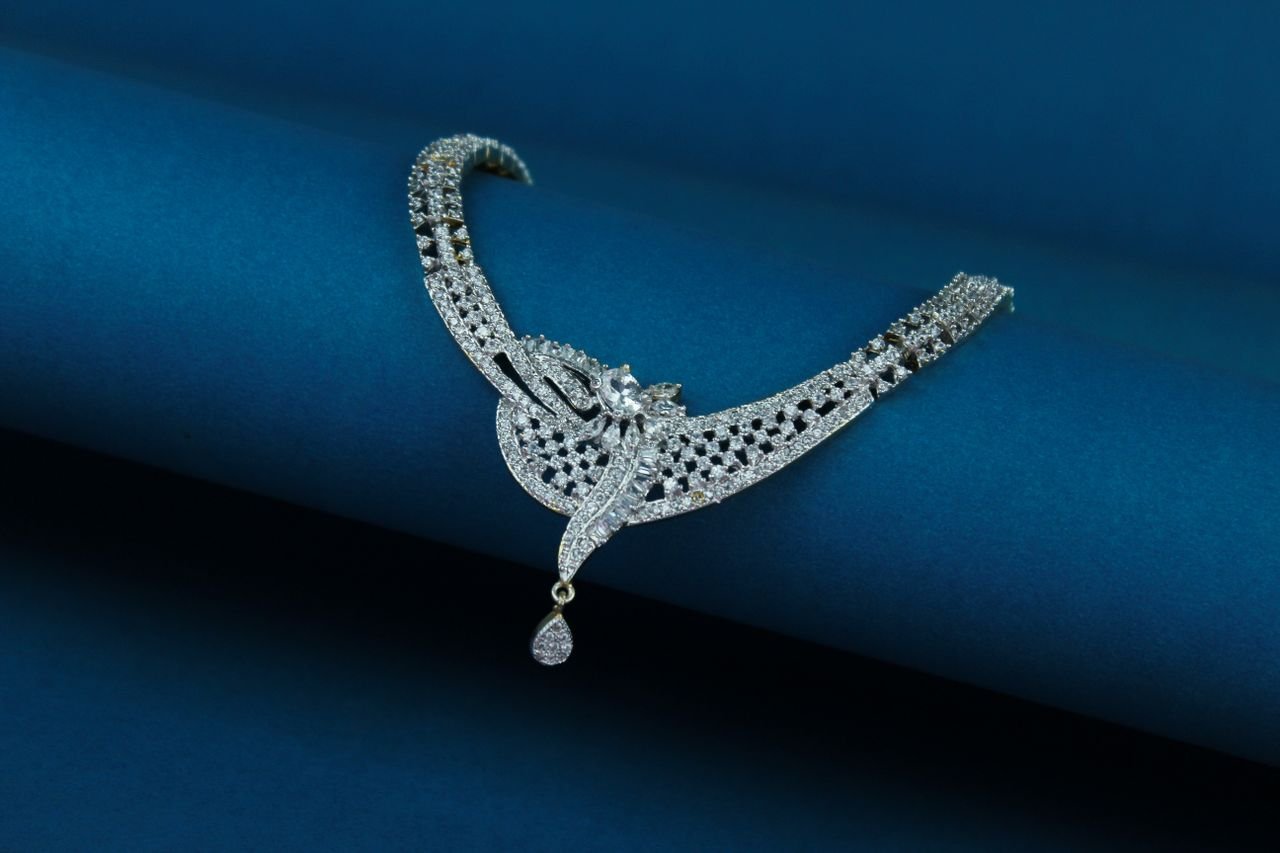 Necklaces Close-up of a luxury diamond necklace on a deep blue background.