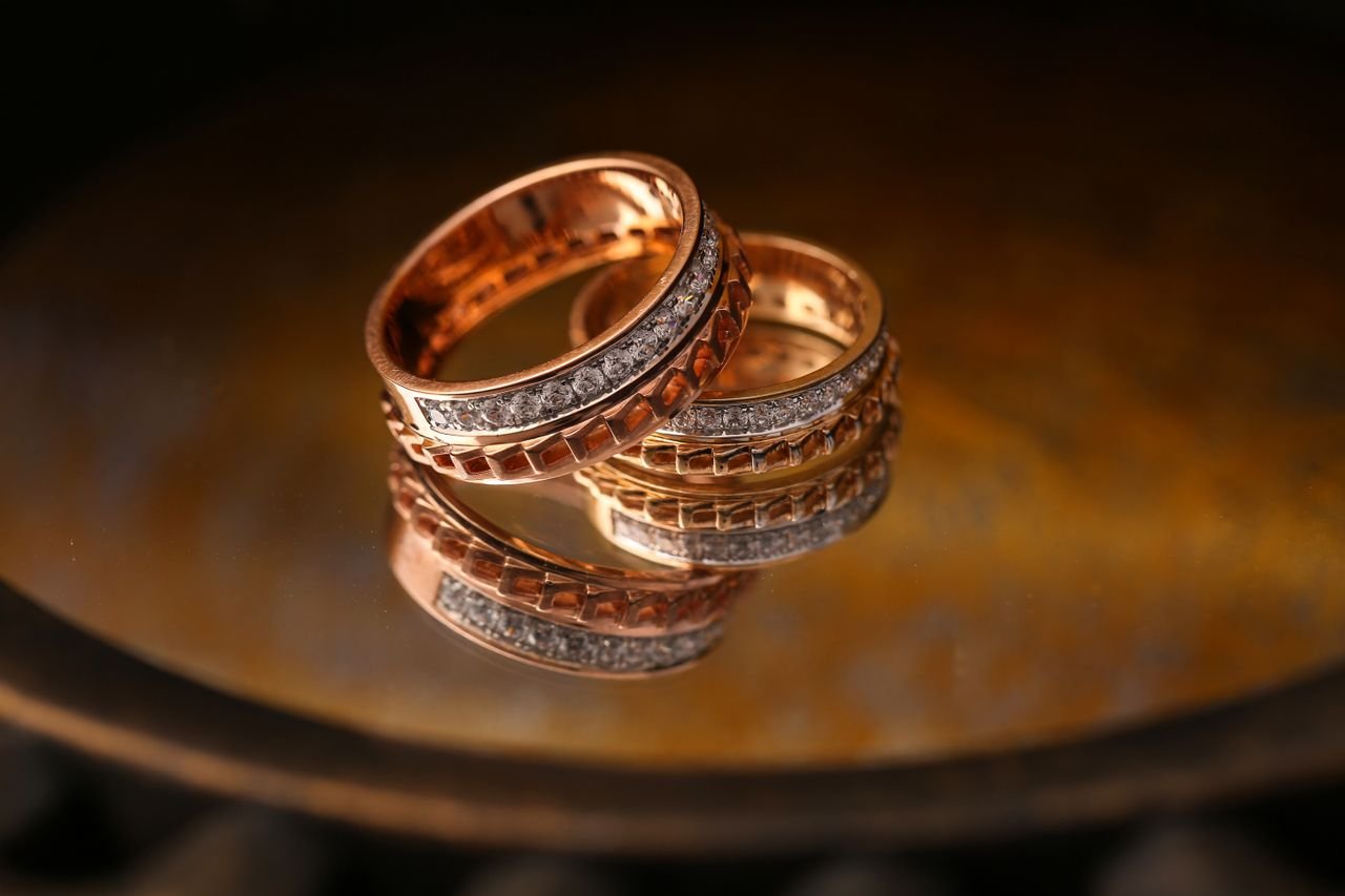 Stacking Rings Close-up of luxury gold and diamond wedding rings reflecting light beautifully.
