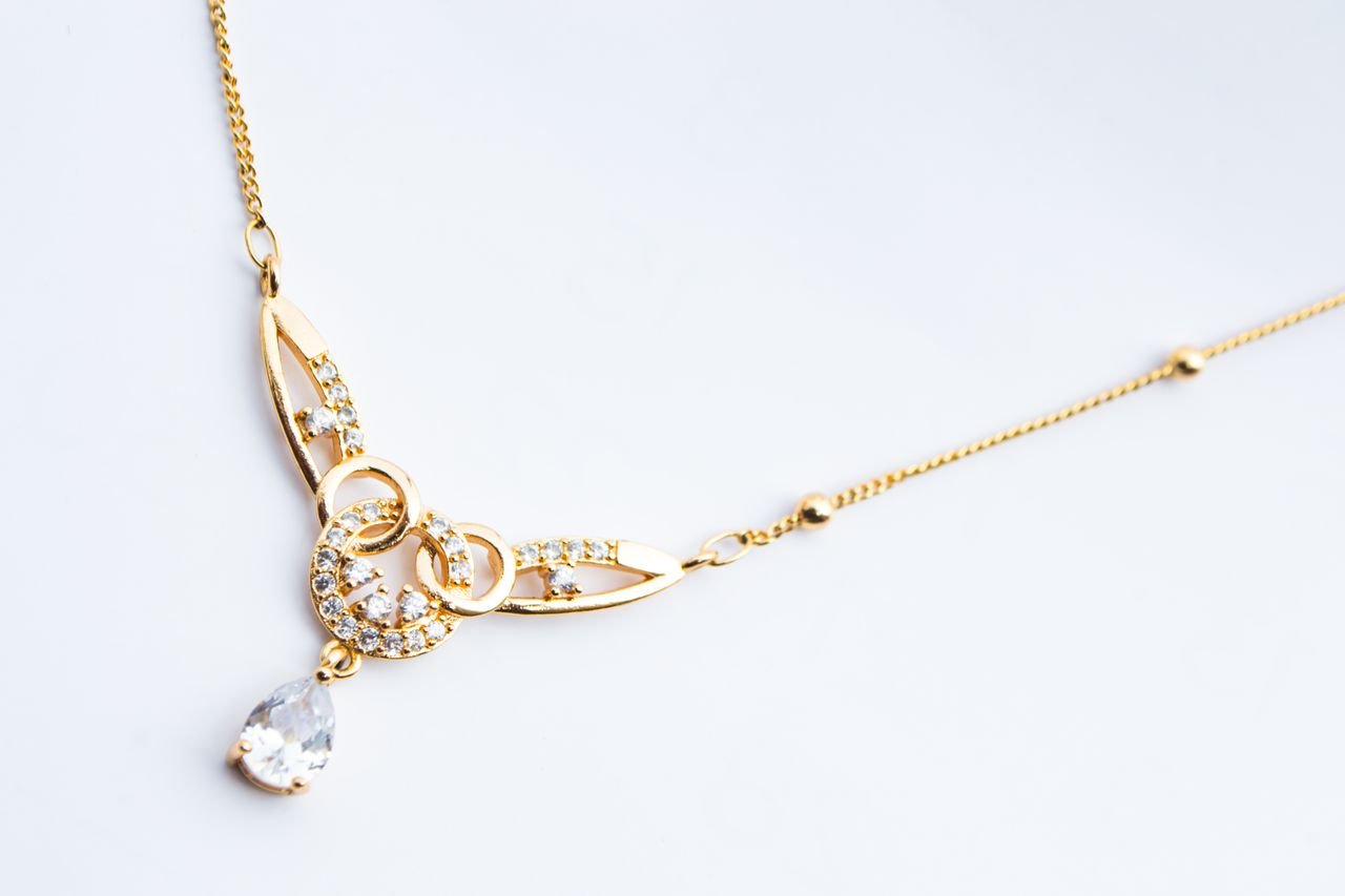 Diamond Necklaces Luxury gold necklace featuring diamond accents on a white background.