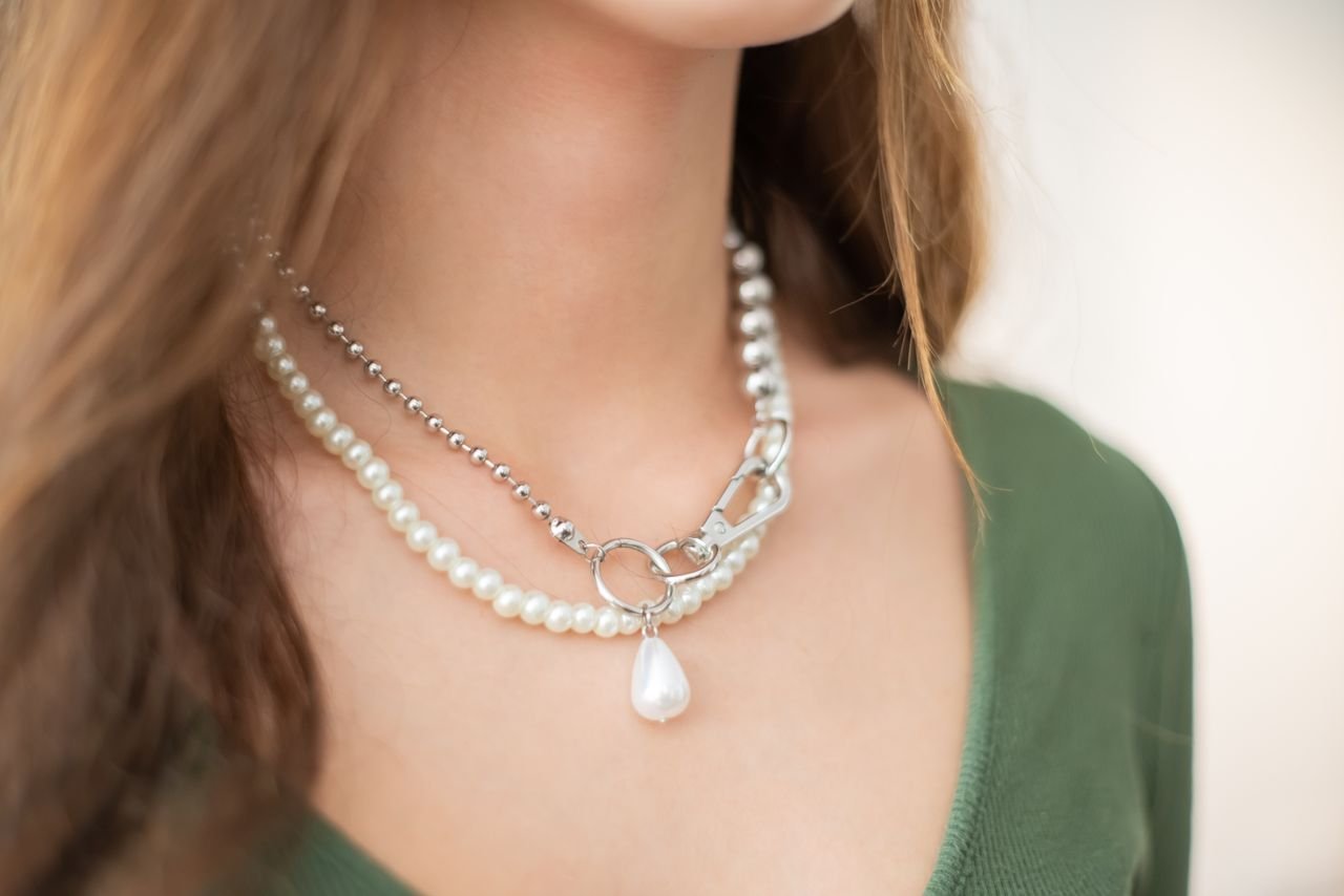 Necklaces Close-up of a woman's neck adorned with elegant layered pearl necklaces.